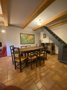 a dining room with a wooden table and chairs at Eden in Le Thor