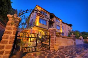 a house with a gate in front of it at Alphan Cappadocia in Uçhisar