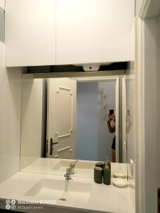 a person taking a picture of a bathroom sink at Oporto apartment Batalha in Porto