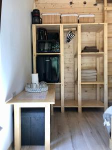 a kitchen with a wooden table and a shelf at Domeniul Horj Casa din Stejar Moisei in Moisei