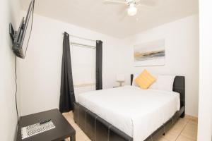 a bedroom with a bed and a flat screen tv at Hollywood private apartments in Hollywood