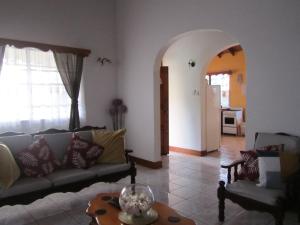 a living room with a couch and a table at Delightful 4bed modern villa with WiFI in Gros Islet