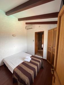 um quarto com uma cama com um cobertor listrado em A Casa di Furtunatu em Santa-Reparata-di-Balagna