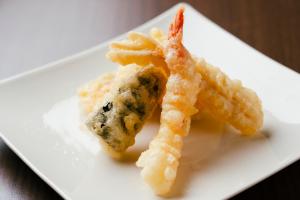 a white plate with a piece of food on it at Keisei Richmond Hotel Tokyo Oshiage in Tokyo