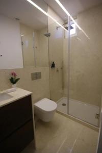 a bathroom with a toilet and a shower and a sink at Timeless Ambassador -Belém in Lisbon