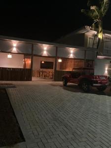 a truck parked in front of a house at night at Pousada Sela Gineta in Fernando de Noronha