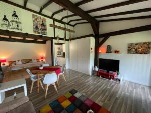 a living room with a table and a bedroom at Ferienwohnung Studio 5 in Siegsdorf +10 photos