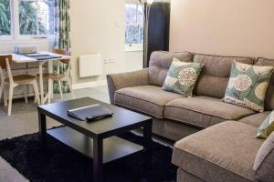 a living room with a couch and a table at Beautiful 1-Bed Apartment in central Ulverston in Ulverston