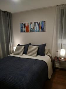 En eller flere senge i et værelse på Tranquilo y Acogedor departamento en Con Con