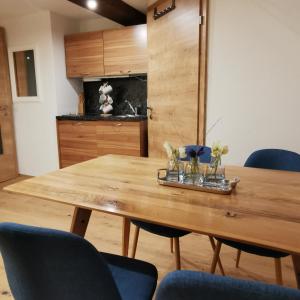 a dining room with a wooden table and chairs at Lutzmannhof in Irdning