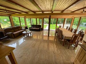 a large living room with a table and chairs at Pensiunea La Rus I si II in Ciucea