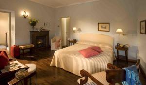 a bedroom with a bed and a living room at Marcarini Agriturismo in Neviglie
