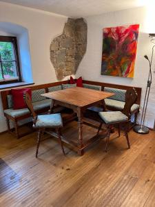 een houten tafel en stoelen in een kamer bij Ferienwohnung Woferlbauer in Au