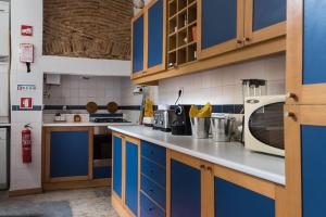 a kitchen with blue cabinets and a counter top at Magnificent Historical City Centre Apart with Terrace in Lisbon