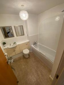 ein Badezimmer mit einer Badewanne, einem WC und einem Waschbecken in der Unterkunft Hopetoun Apartment with free parking in Edinburgh