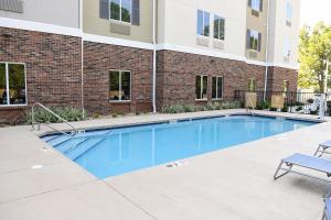 a swimming pool in front of a building at Candlewood Suites Valdosta Mall, an IHG Hotel in Valdosta