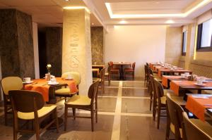 a dining room with wooden tables and chairs at Peyk Hotel in Istanbul