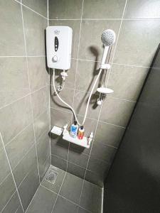 a shower with a hair dryer in a bathroom at Bangi,4-7pax,Cozy Studio,Near UKM in Kajang