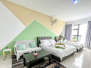 a bedroom with two beds and a green wall at Bangi,4-7pax,Cozy Studio,Near UKM in Kajang
