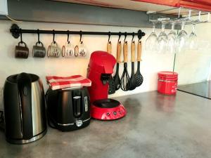 a kitchen with utensils hanging on a wall at Gîte l'Echappée belle in Castelnau-Pégayrols