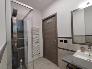 a bathroom with a shower and a sink and a door at Triple C or Quadruple D - MyAostaProject in Aosta