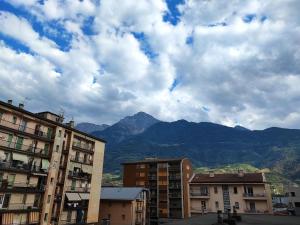 a city with buildings and mountains in the background at Triple C or Quadruple D - MyAostaProject in Aosta