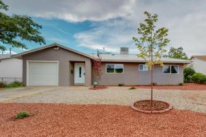 a small tree in front of a house at Comfortable 3-bedroom home with spacious backyard in Albuquerque