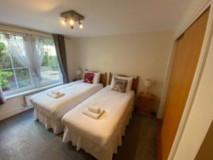 a bedroom with two beds and a window at Hopetoun Apartment with free parking in Edinburgh