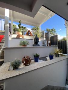 a patio with a statue and potted plants at Les Suites du Lac in Aix-les-Bains