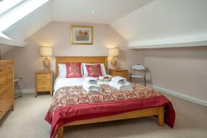 a bedroom with a bed with two towels on it at The Haven at Coastguard Court - Aldeburgh Coastal Cottages in Aldeburgh