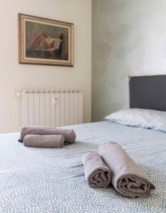 um quarto com uma cama com toalhas em BLUE LAKE ARONA - cozy apartment in city center em Arona