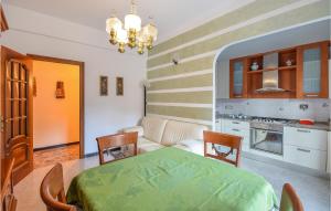 a kitchen with a table and chairs in a room at Stunning Apartment In Genova With 2 Bedrooms And Wifi in Genoa