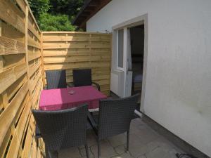 a pink table and chairs on a patio at Hotel-Garni Seestrand in Zell am See
