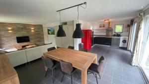 a kitchen and dining room with a wooden table and chairs at Vakantiehuisje drenthe gasselterveld in Gasselte