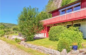 a red house on the side of a mountain at Amazing Apartment In Lindesnes With Wifi in Tryland