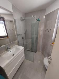 a bathroom with a shower and a sink and a toilet at Apartment Marija in Njivice