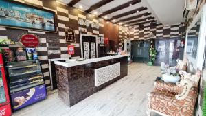 a store with a counter and chairs in a store at Hotel Amritsar Inn in Amritsar