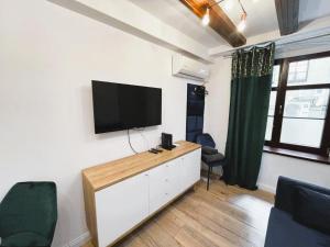a living room with a flat screen tv on a wall at Strumykowa 19 - Old Town in Toruń