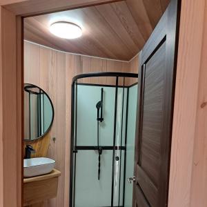 a bathroom with a shower and a glass door at Šventosios Slėnis 