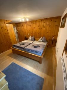 a bedroom with a bed and a blue rug at Ferienhaus zum Ulfenbachtal in Wald-Michelbach