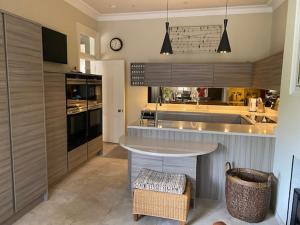 a kitchen with a island in the middle of it at Braid Rd Stunning Villa in Edinburgh