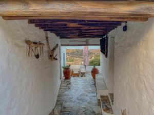 an alley in a house with a wooden ceiling at Sympopoula House in Sifnos