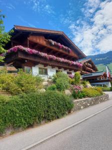 a building with flowers on the side of it at Haus Theresia Alpbach in Alpbach