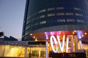 a large building with a large sign in front of it at Hotel Oval in Surabaya
