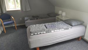 En eller flere senge i et værelse på Ringslund B&B