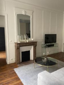 a living room with a fireplace and a tv at Arc de triomphe, Champs Elysées, Foch Avenue Luxury apartment in Paris