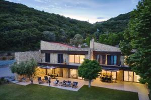 an aerial view of a house in the mountains at Develikia Private Villas Villa-1 Ierissos in Develíkia