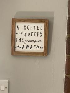 a sign that says a coffee a day keeps the supermarket away at Boutique apartment in Wicklow