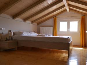 a bedroom with a large bed with a window at TH Studio in Myrina