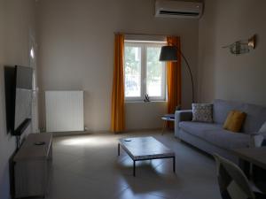 a living room with a couch and a table at TH Studio in Myrina